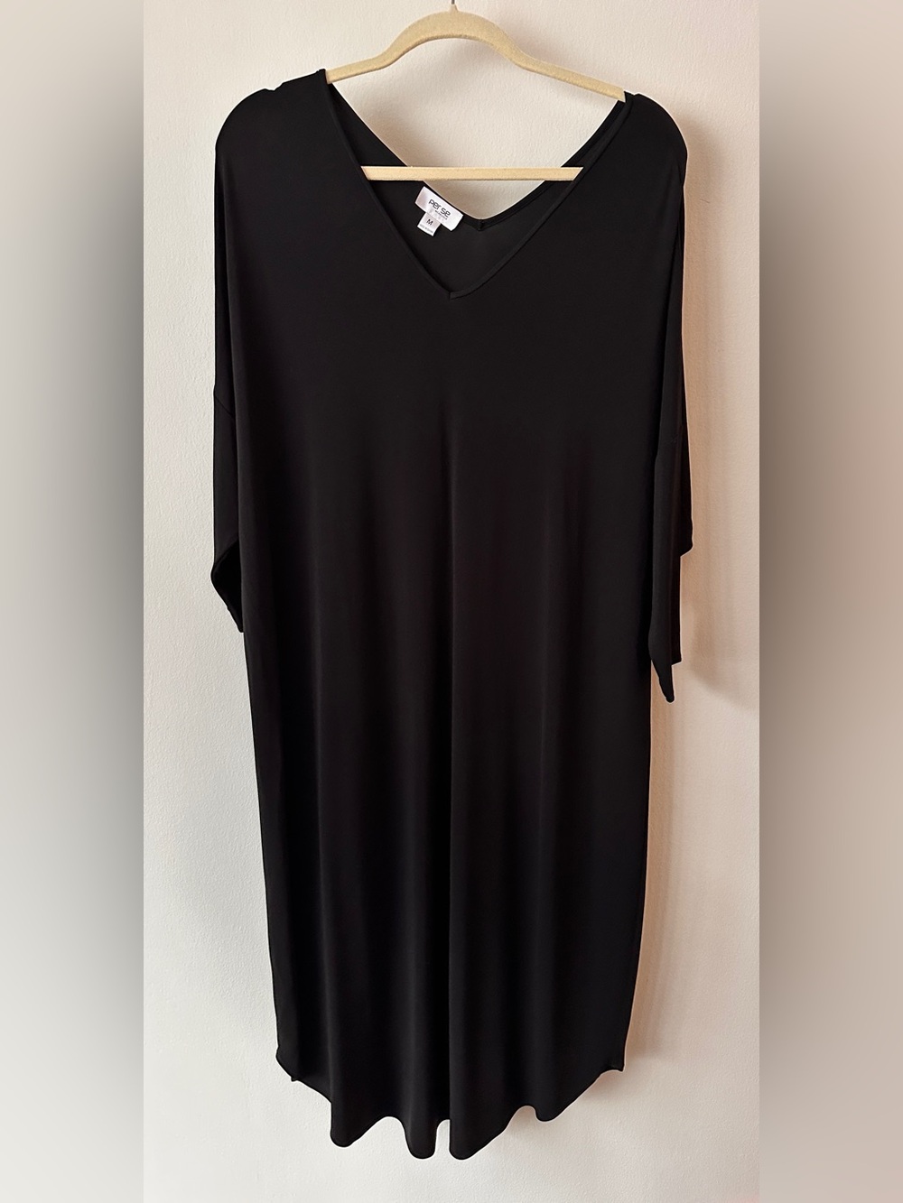 Perse black V-neck shift dress with half sleeves.